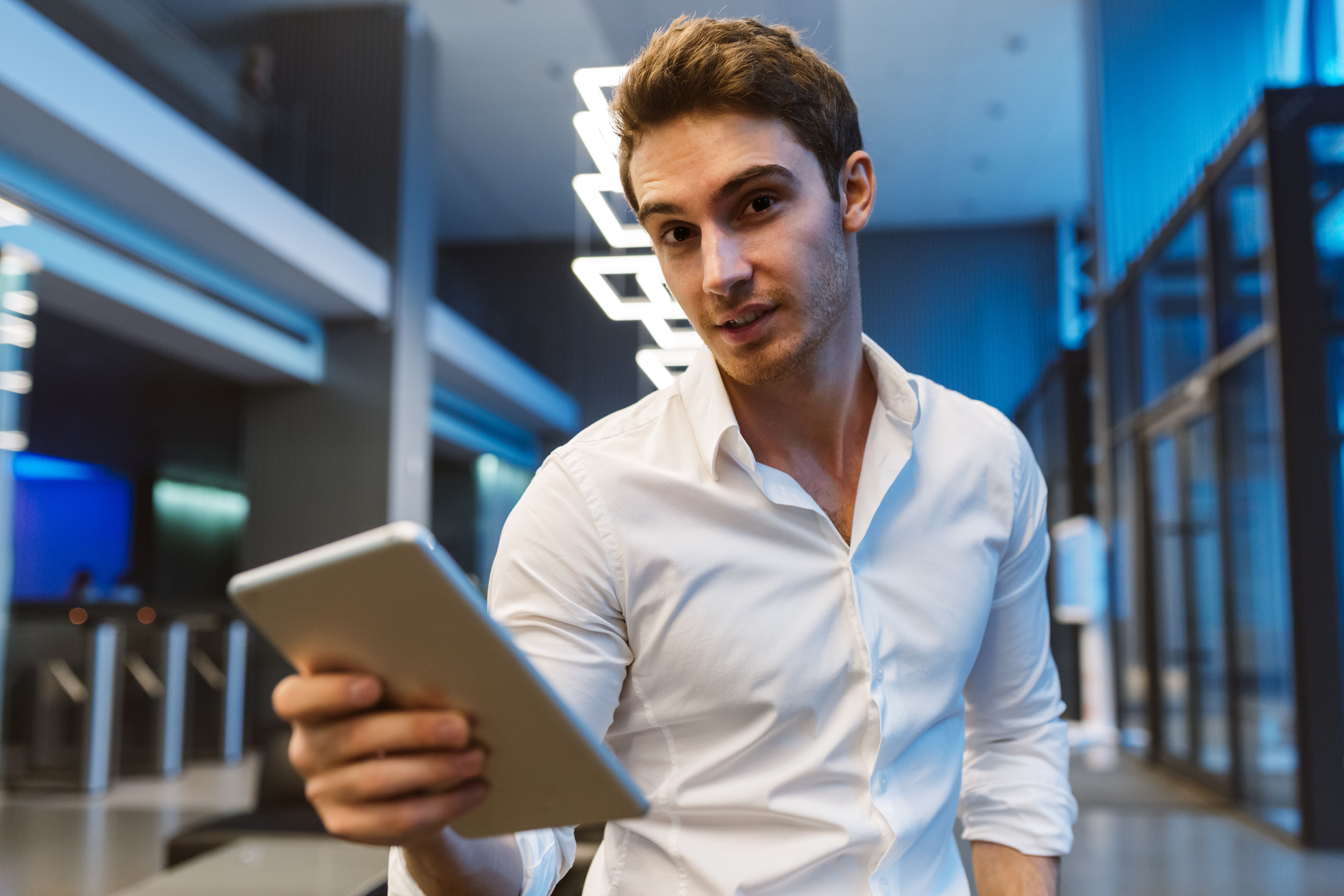 business-man-in-shirt-halding-laptop-computer-in-office-front-view-SBI-302894011